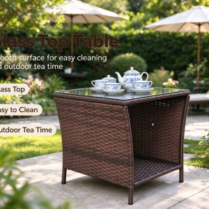 PE rattan side table with glass top and lower shelf on a garden patio