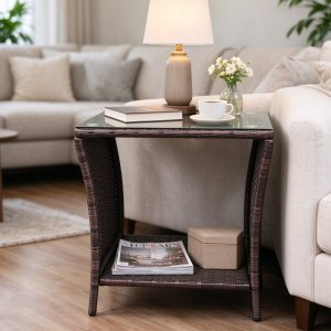 Rattan glass-top side table with lower storage shelf beside a sofa